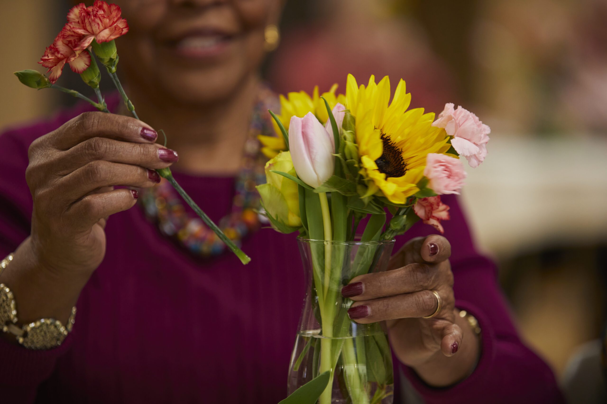 A woman arranges sunflowers