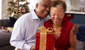 Seniors Exchanging Christmas Gifts At Home