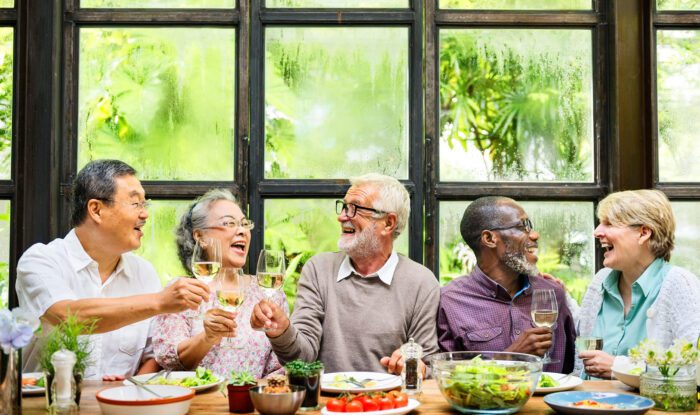 a group of friends in Assisted Living enjoy a meal together