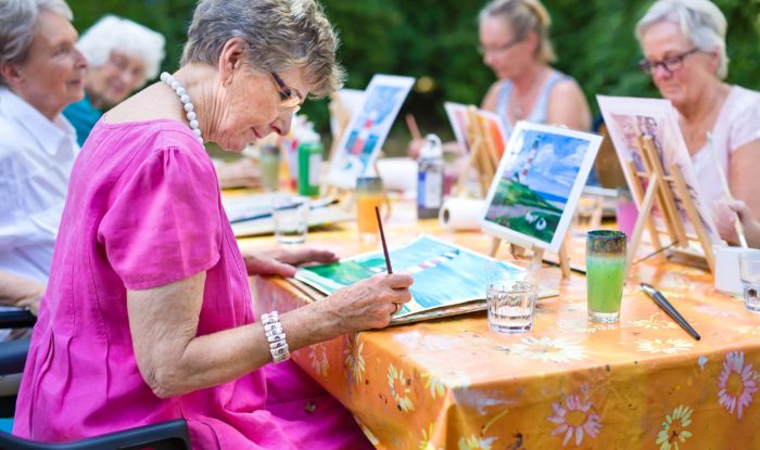 An elderly woman paints in Lakewood Colorado