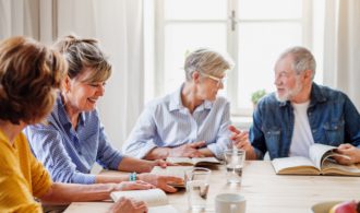 Senior people in reading group in Generations club, talking.